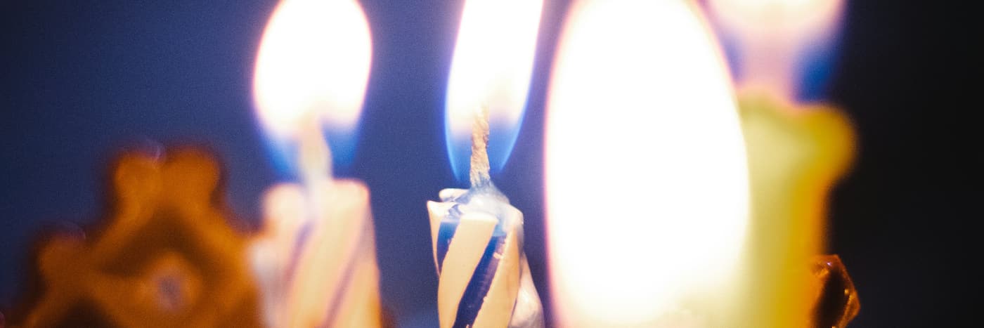 Lit candles on a table, warm and close